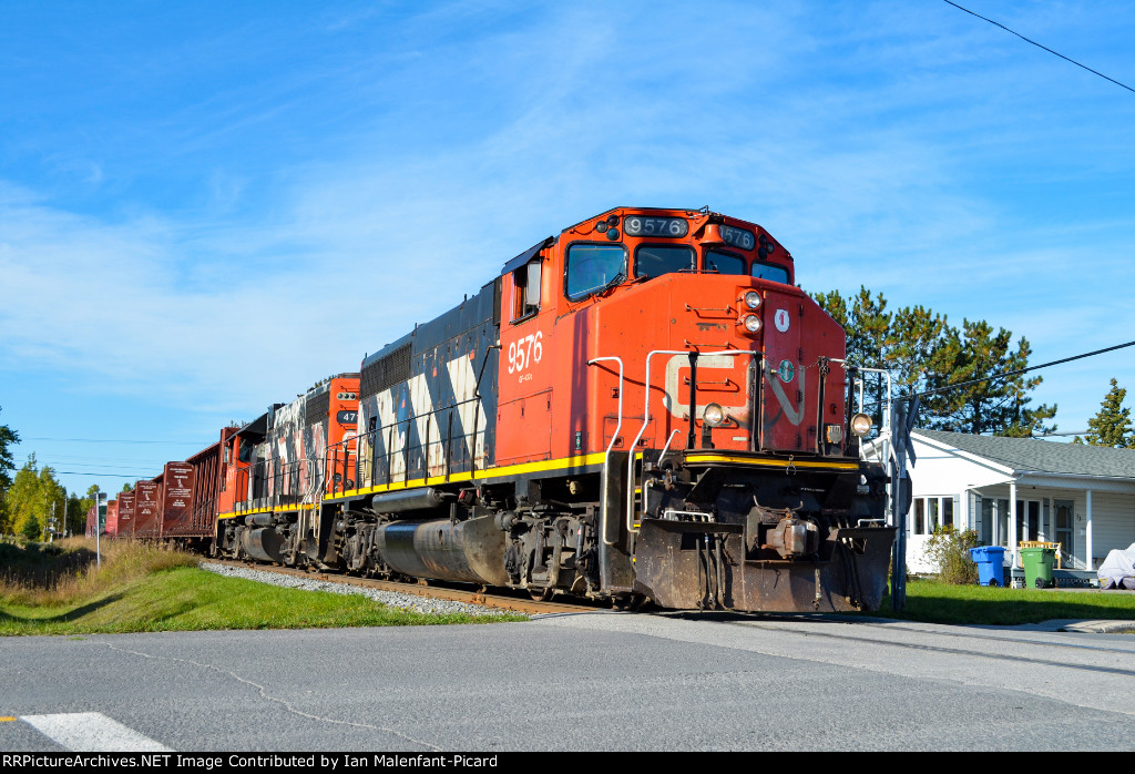 CN 9576 leads 561 at St Jean Baptiste street